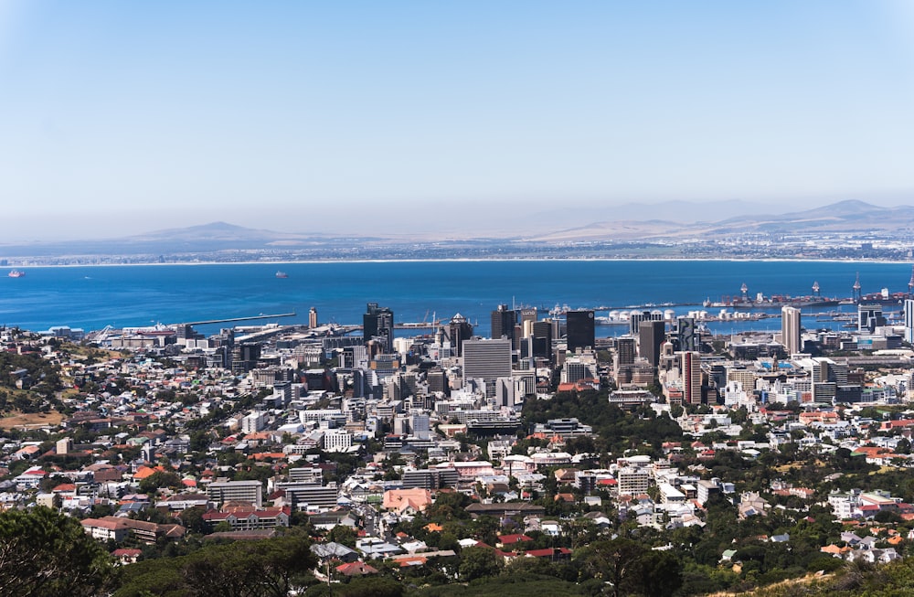 a view of a city with a body of water in the background