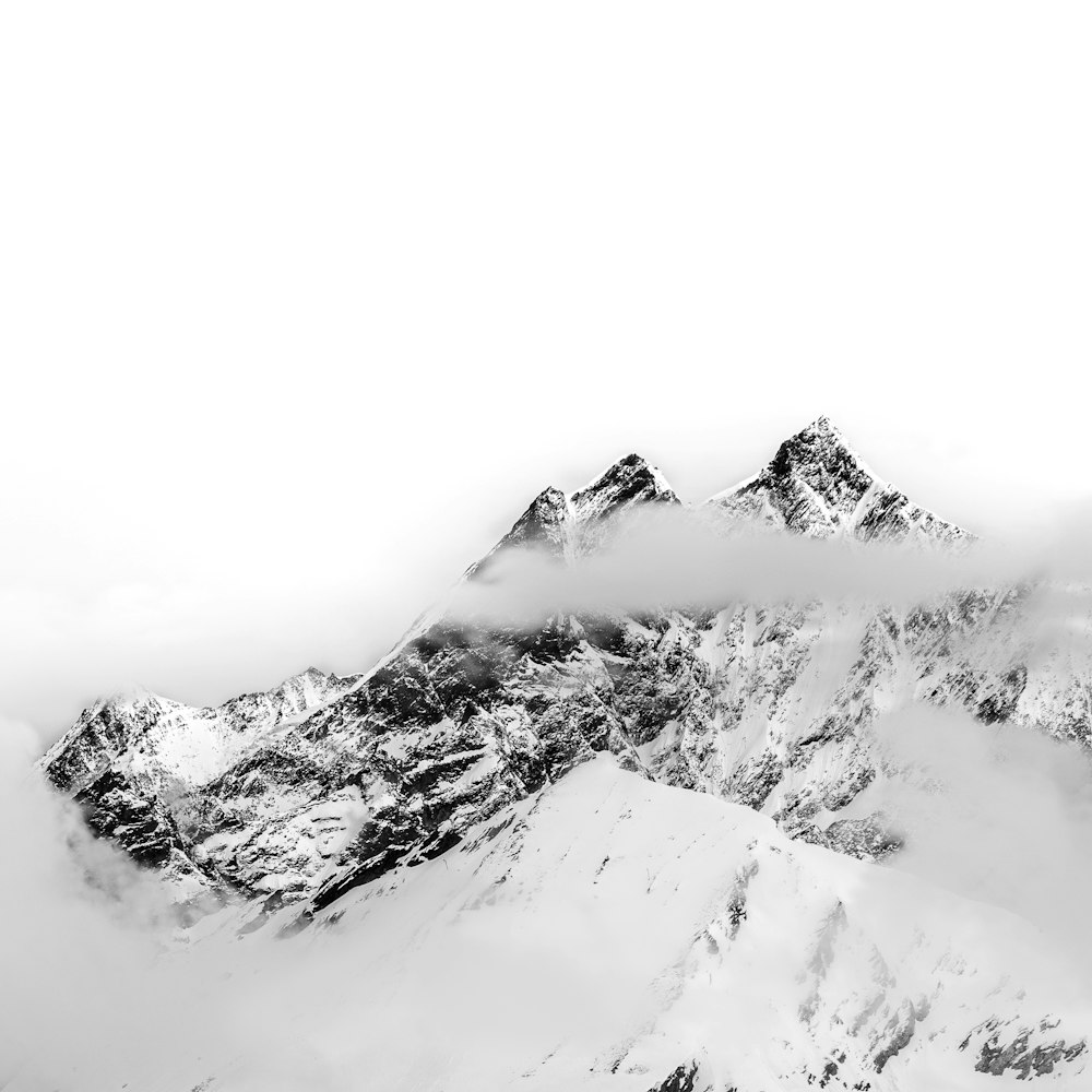 a black and white photo of snow covered mountains