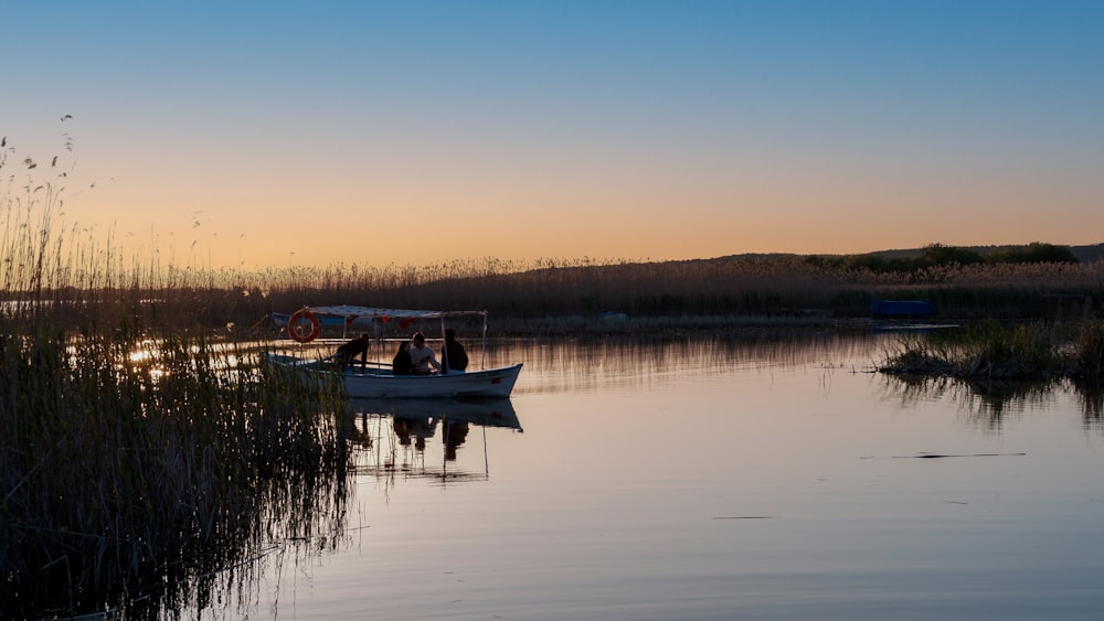 a couple of people in a small boat on a lake