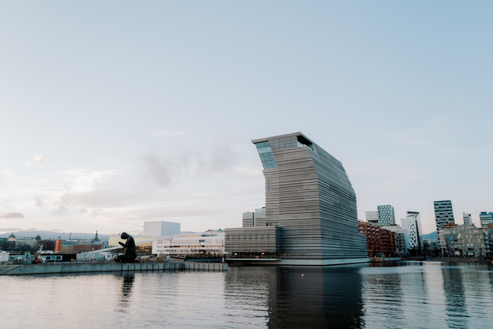 a large body of water with a tall building in the background