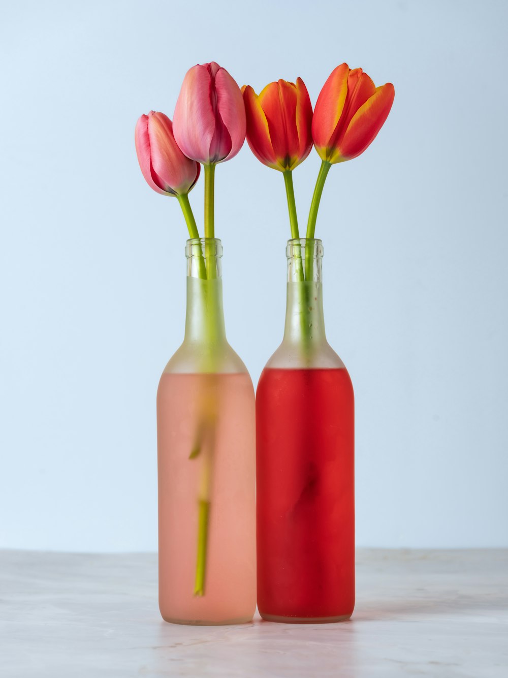 a couple of vases that have flowers in them