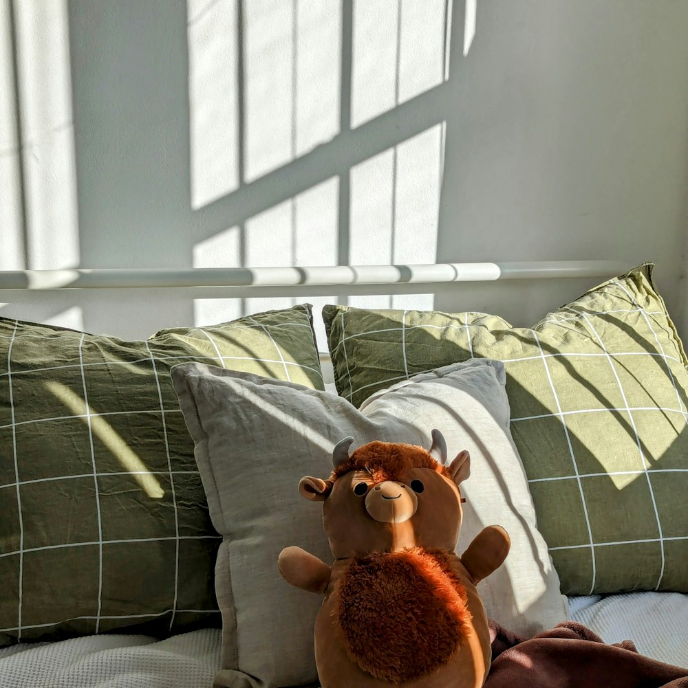 a stuffed animal sitting on top of a bed