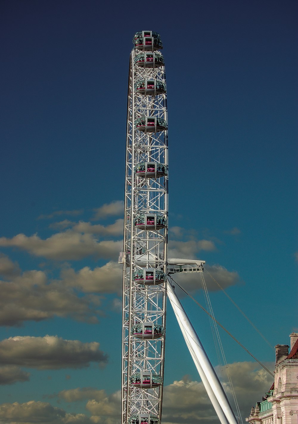 a large ferris wheel sitting next to a tall building