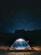 a tent pitched up in the desert at night