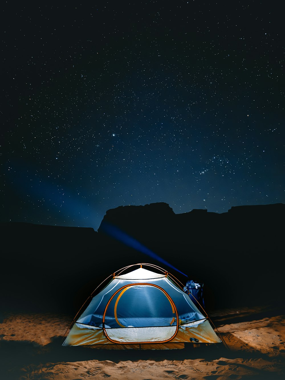 a tent pitched up in the desert at night