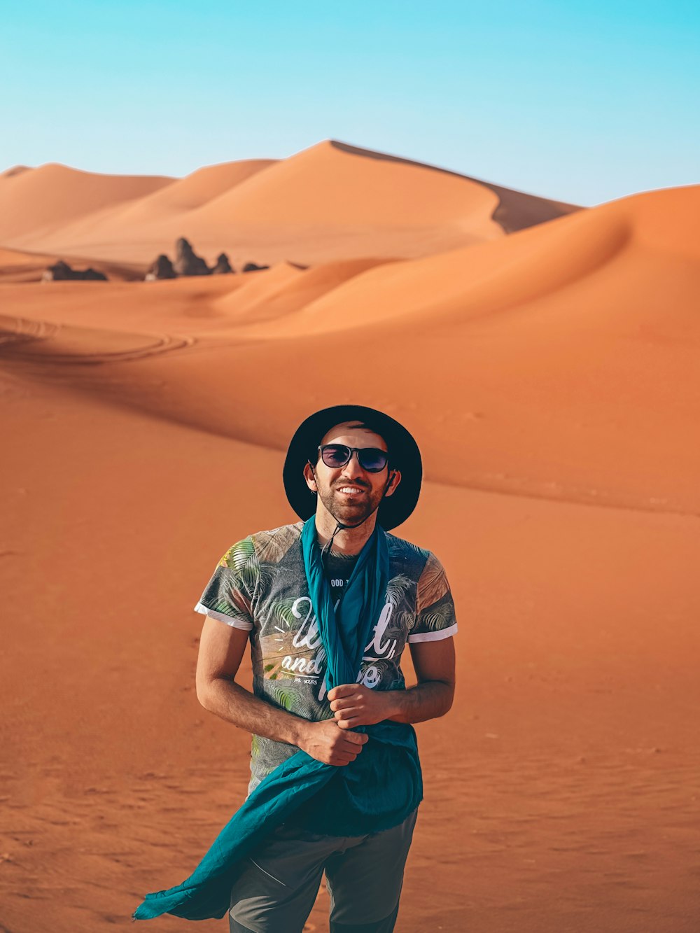 a man standing in the middle of a desert