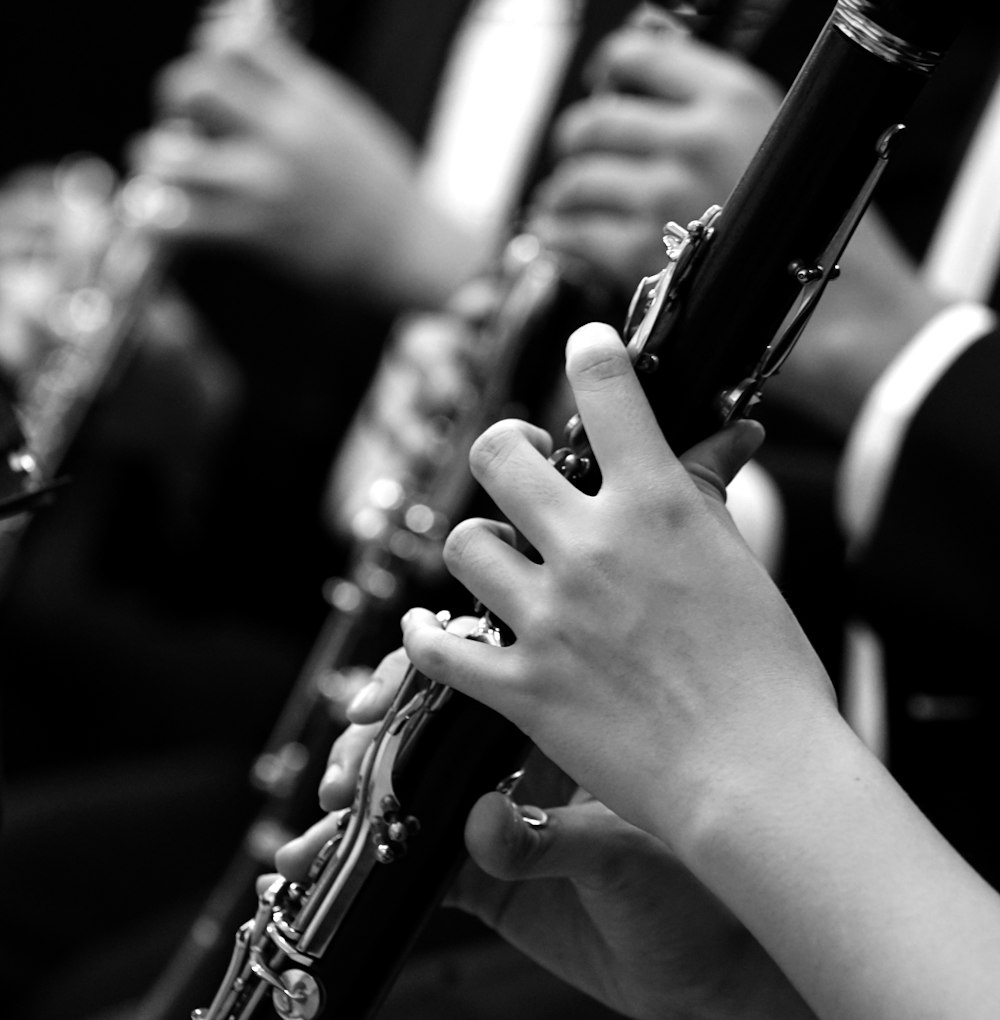 a close up of a person playing a flute