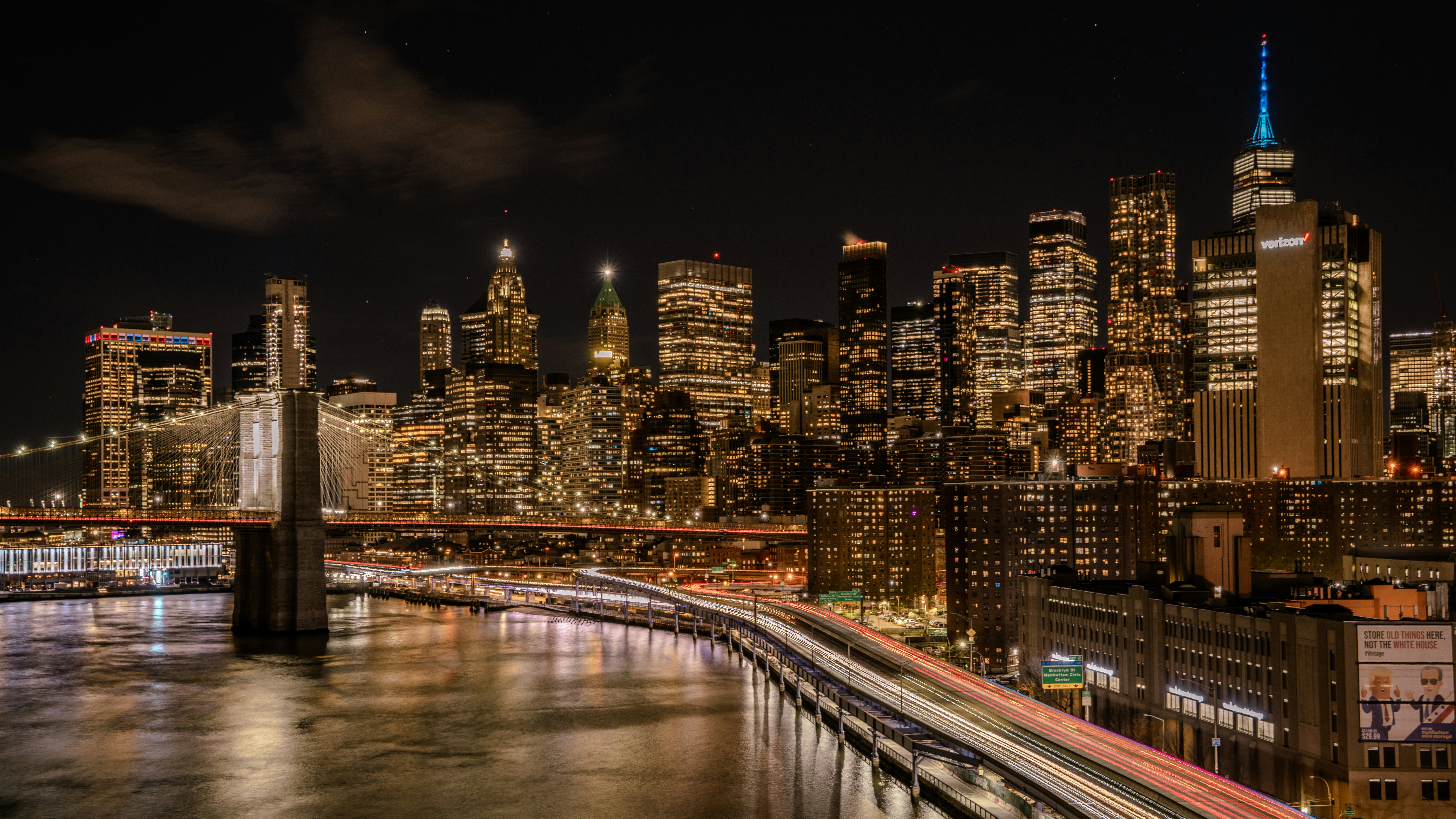 a view of a city at night from a bridge, Manhattan