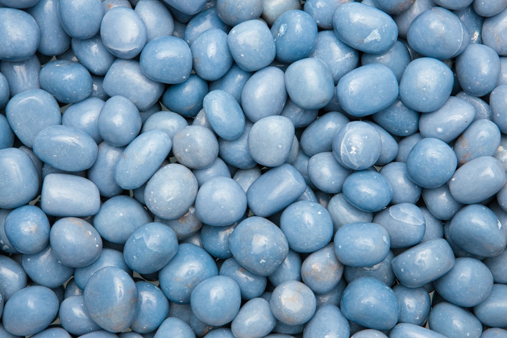 a pile of blue candy eggs in a bowl