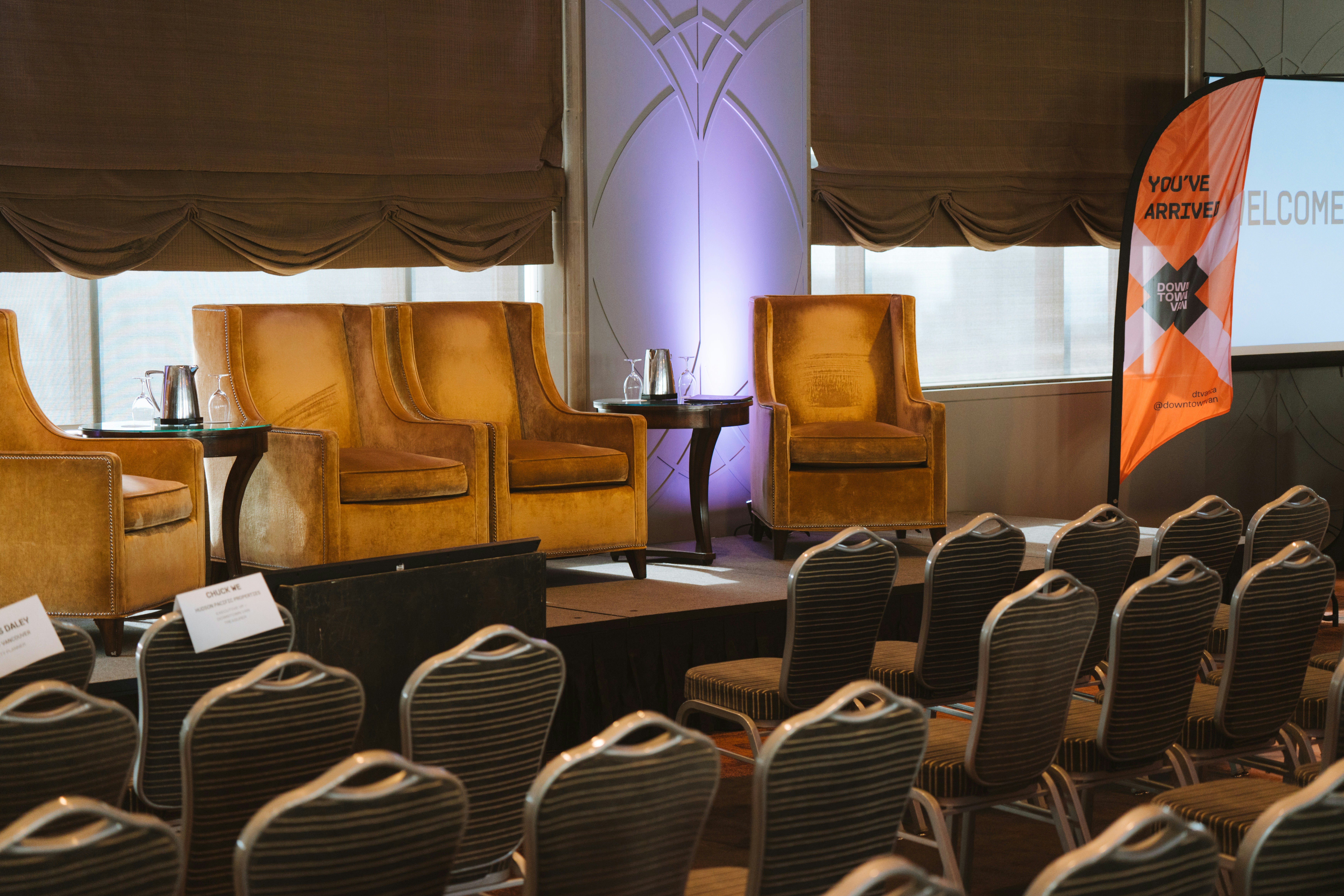 a room filled with chairs and a projector screen