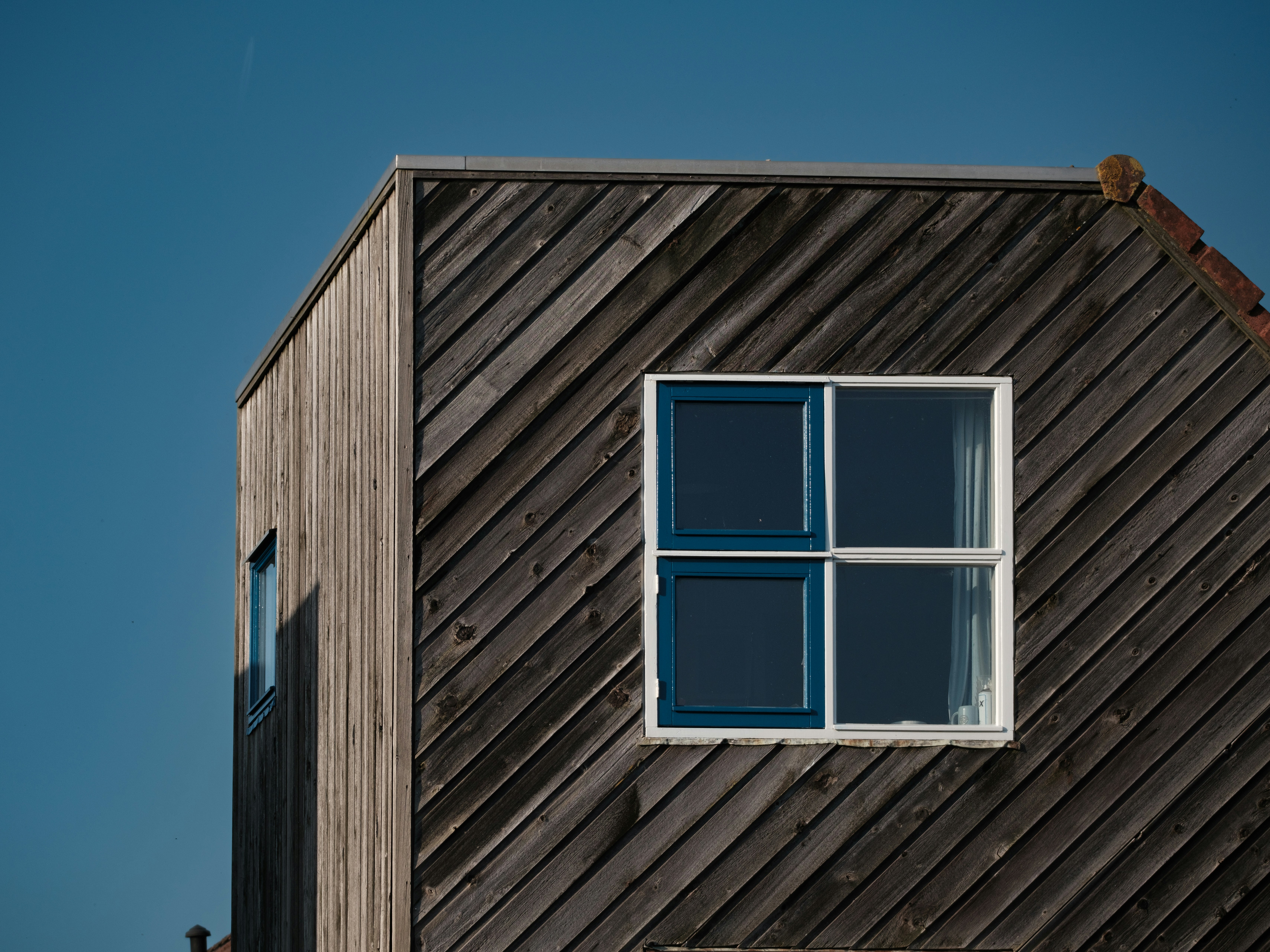 a wooden building with a window on the side of it