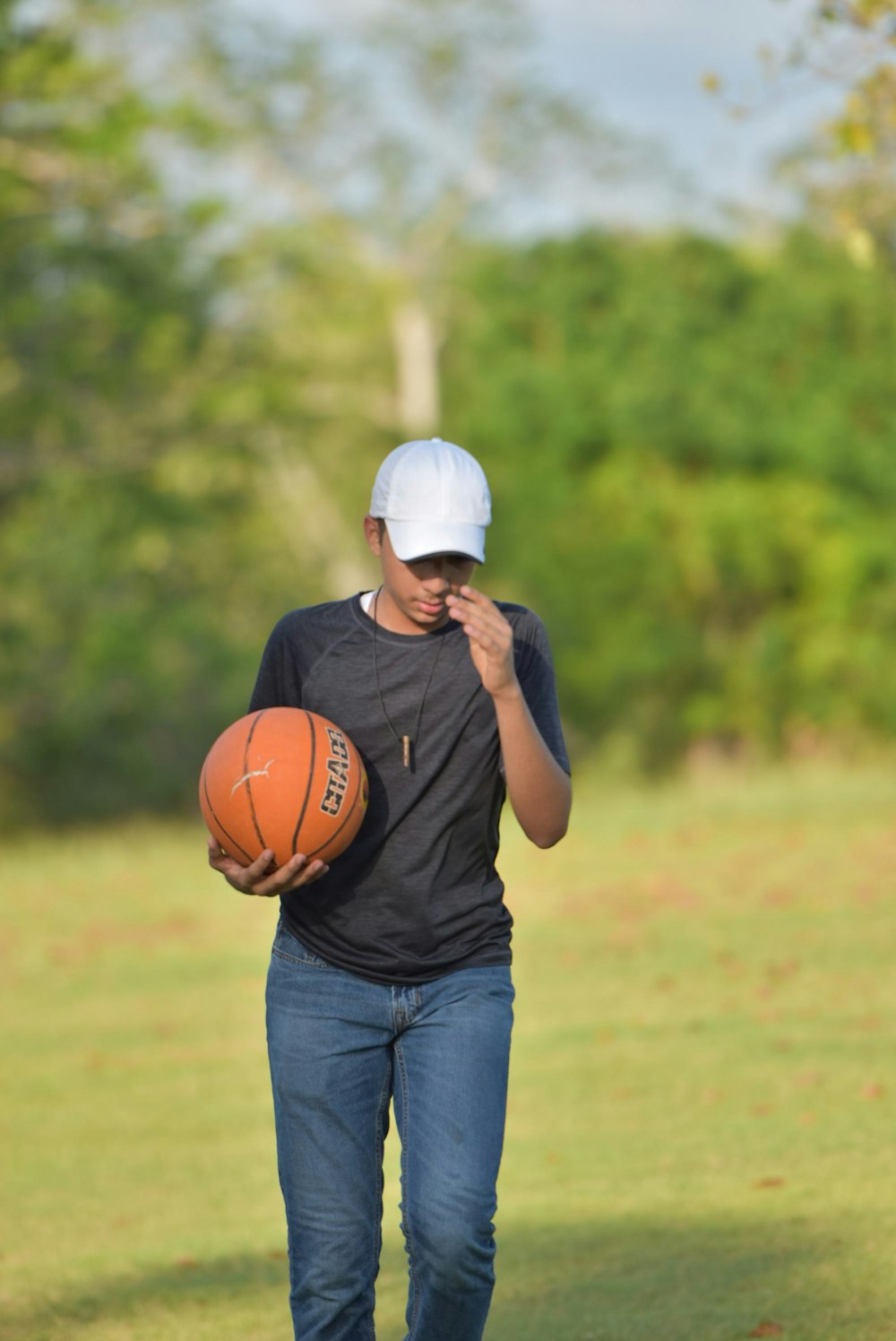 a man walking with a basketball in his hand