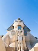 a statue of an egyptian god in front of a building