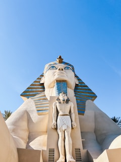 a statue of an egyptian god in front of a building