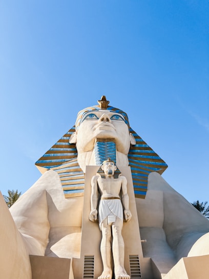 a statue of an egyptian god in front of a building