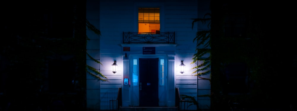 a building with a lit up door at night