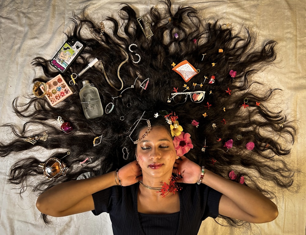 a woman laying on top of a bed covered in hair