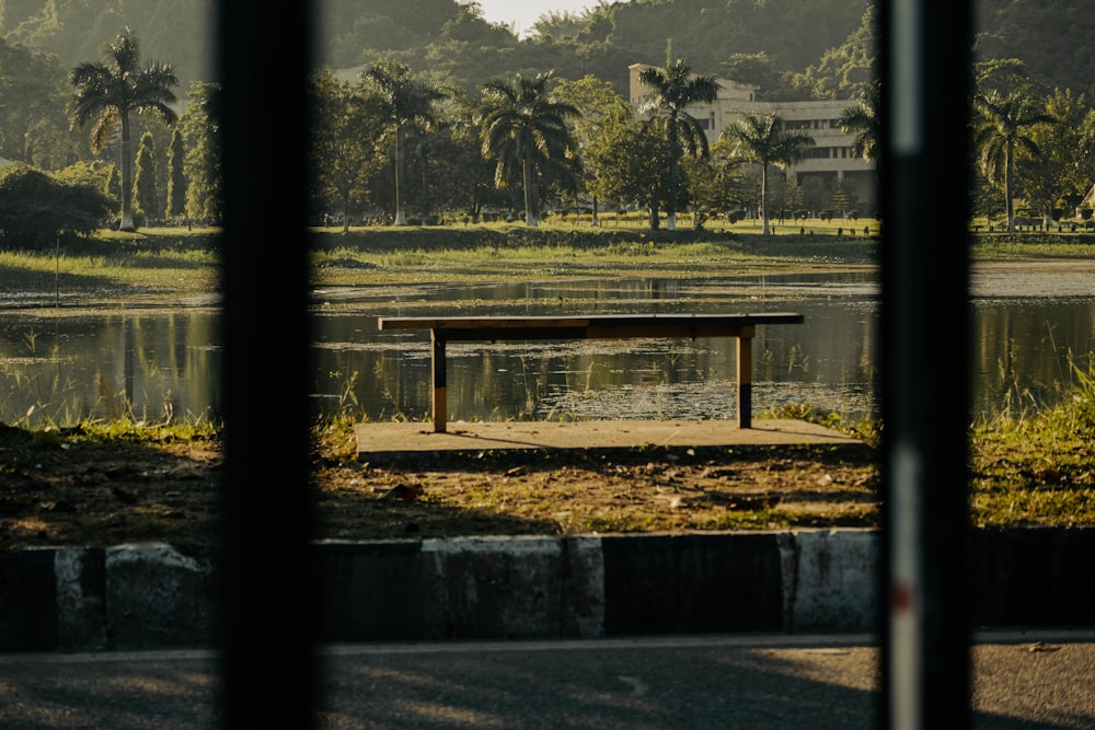 a park bench sitting in front of a lake