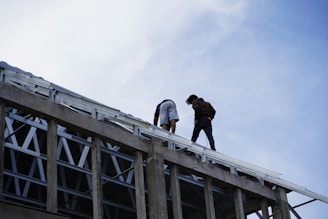 a couple of people standing on top of a building