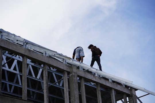 a couple of people standing on top of a building