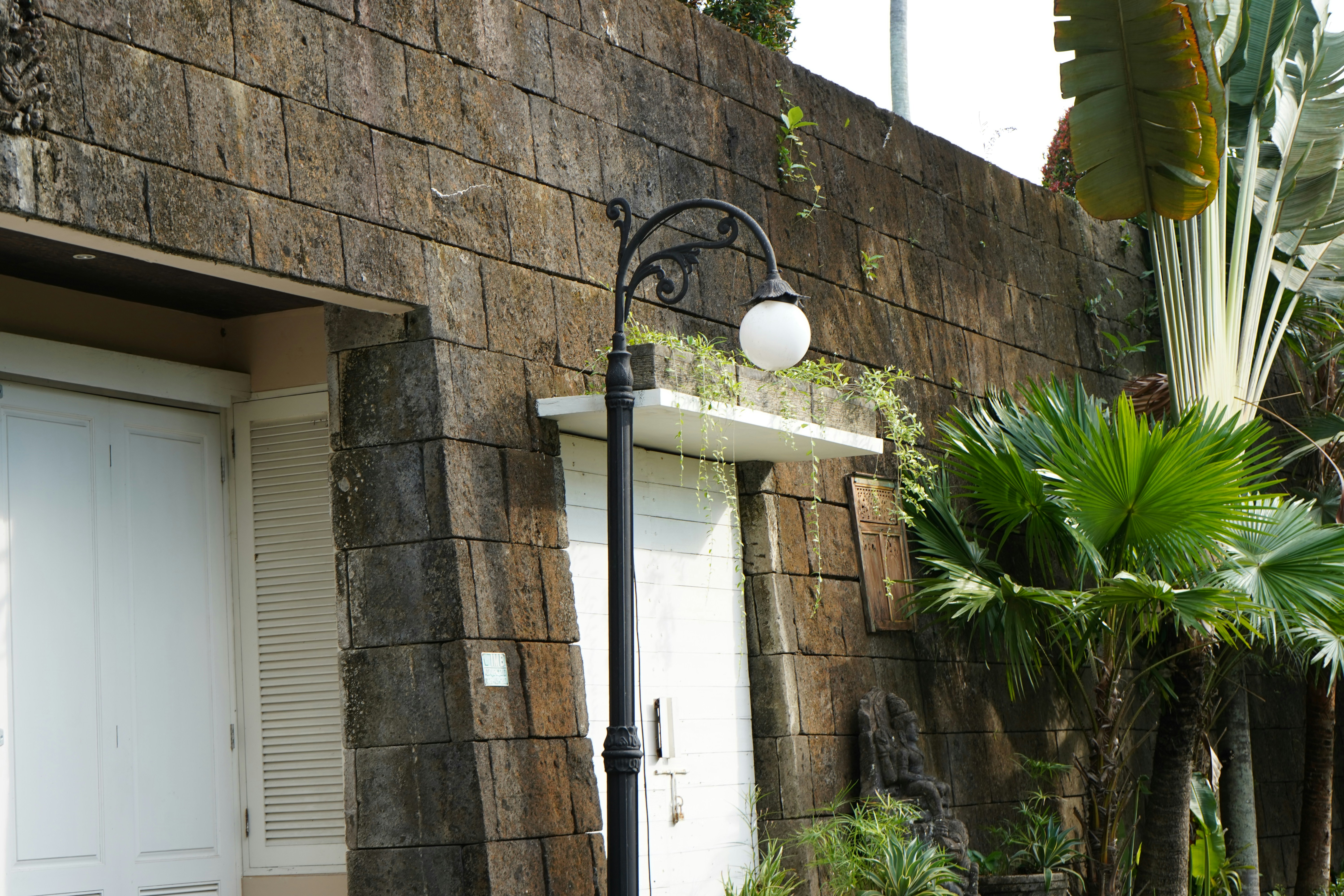 A street light next to a brick building photo – Free Indonesia Image on ...