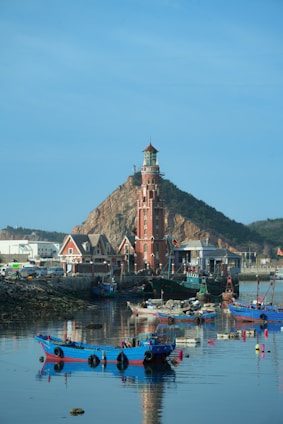 a group of boats floating on top of a body of water