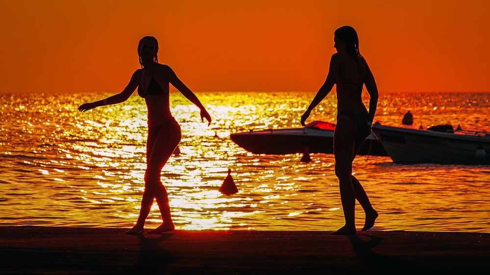 a couple of people that are standing in the water