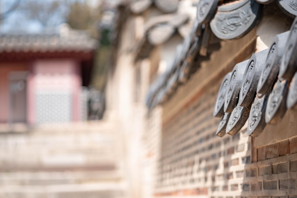 a close up of a brick wall with a building in the background