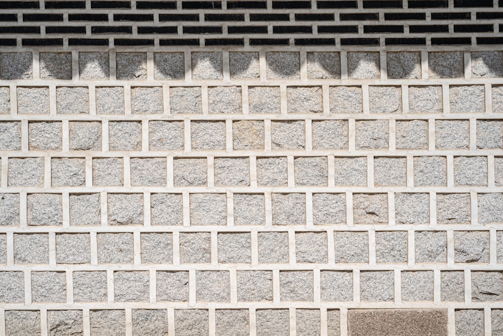 a brick wall with a clock on the side of it