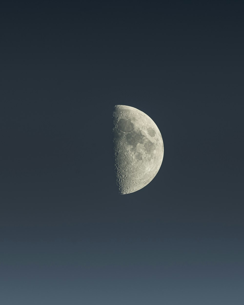 a half moon is seen in the sky