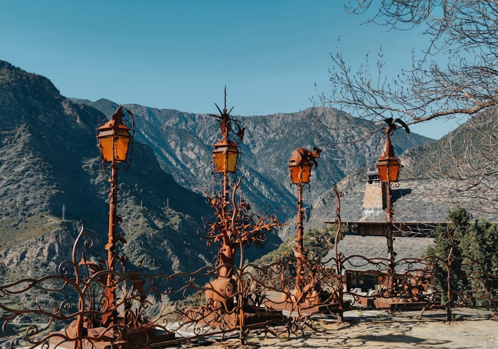 a bunch of rusted out street lights in front of a mountain