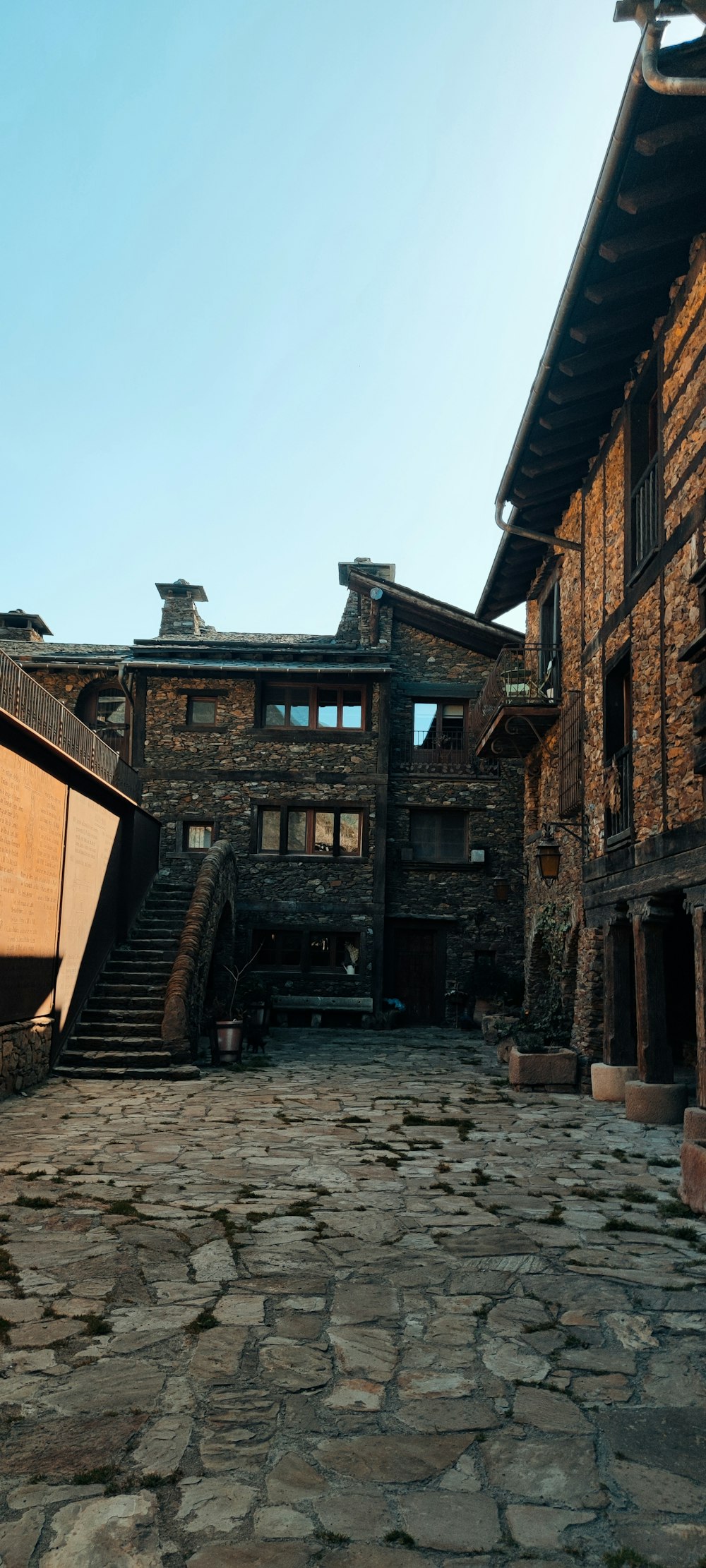 a stone courtyard with steps leading up to a building
