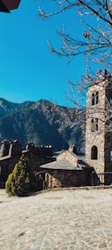 a stone building with a clock on the front of it