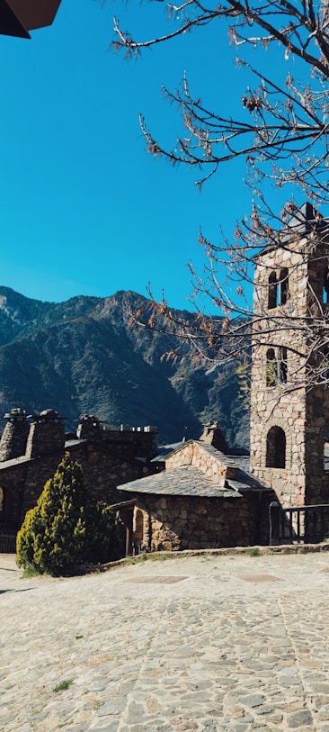 a stone building with a clock on the front of it