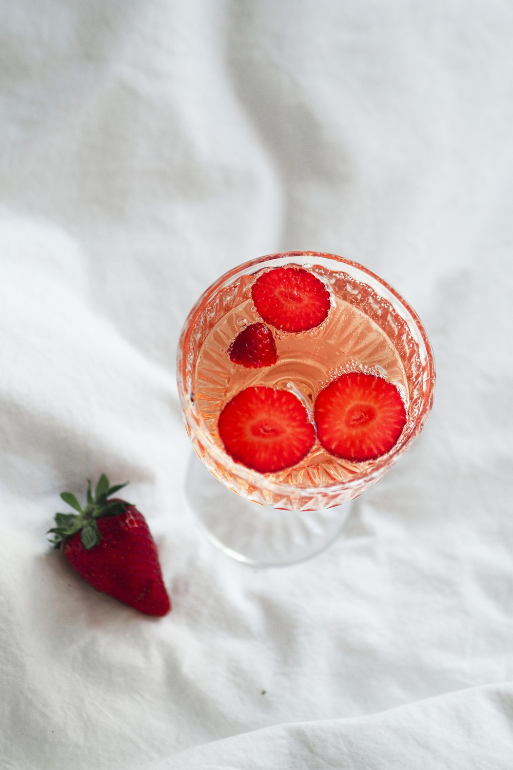 a drink with strawberries in a glass