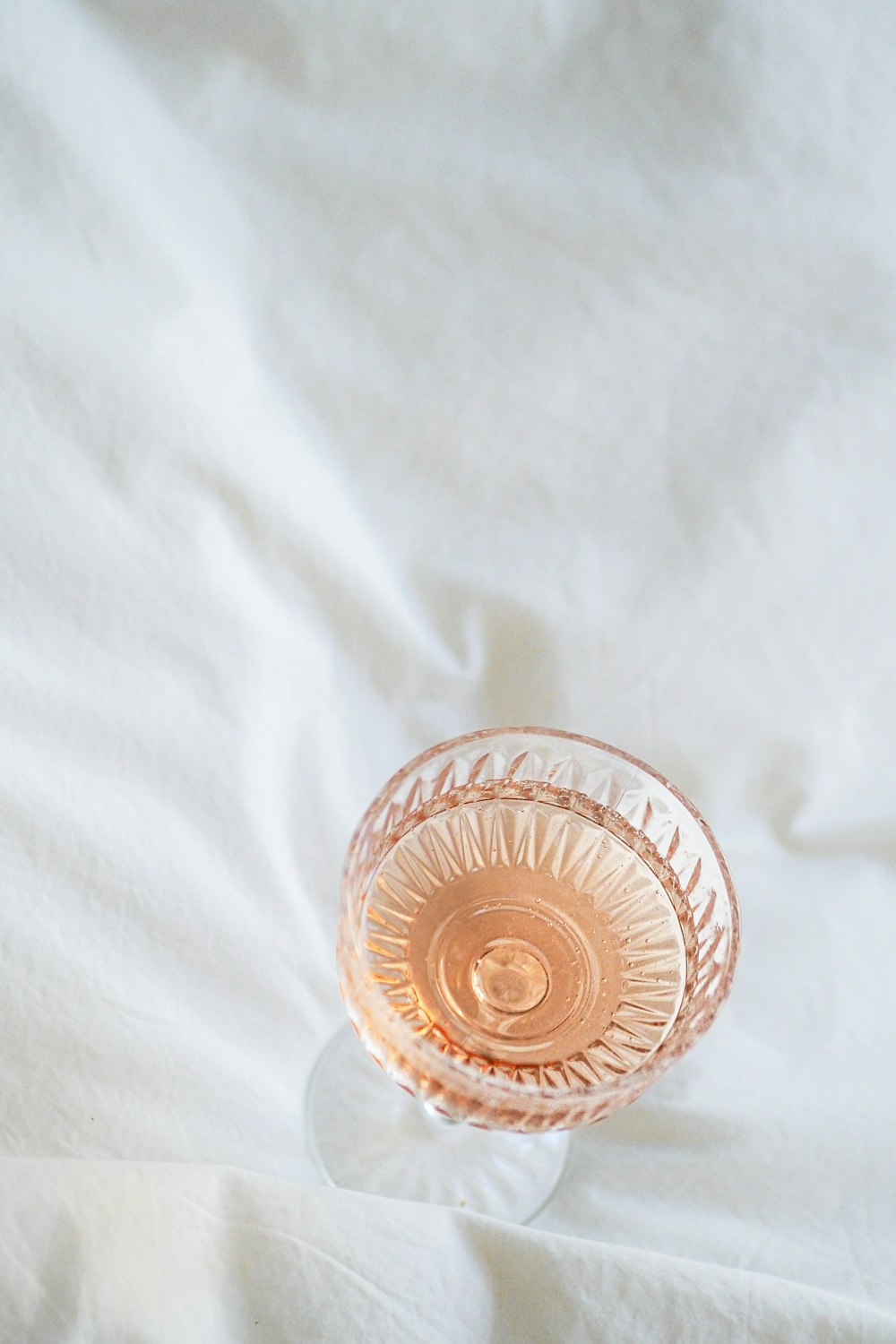 a glass vase sitting on top of a white sheet