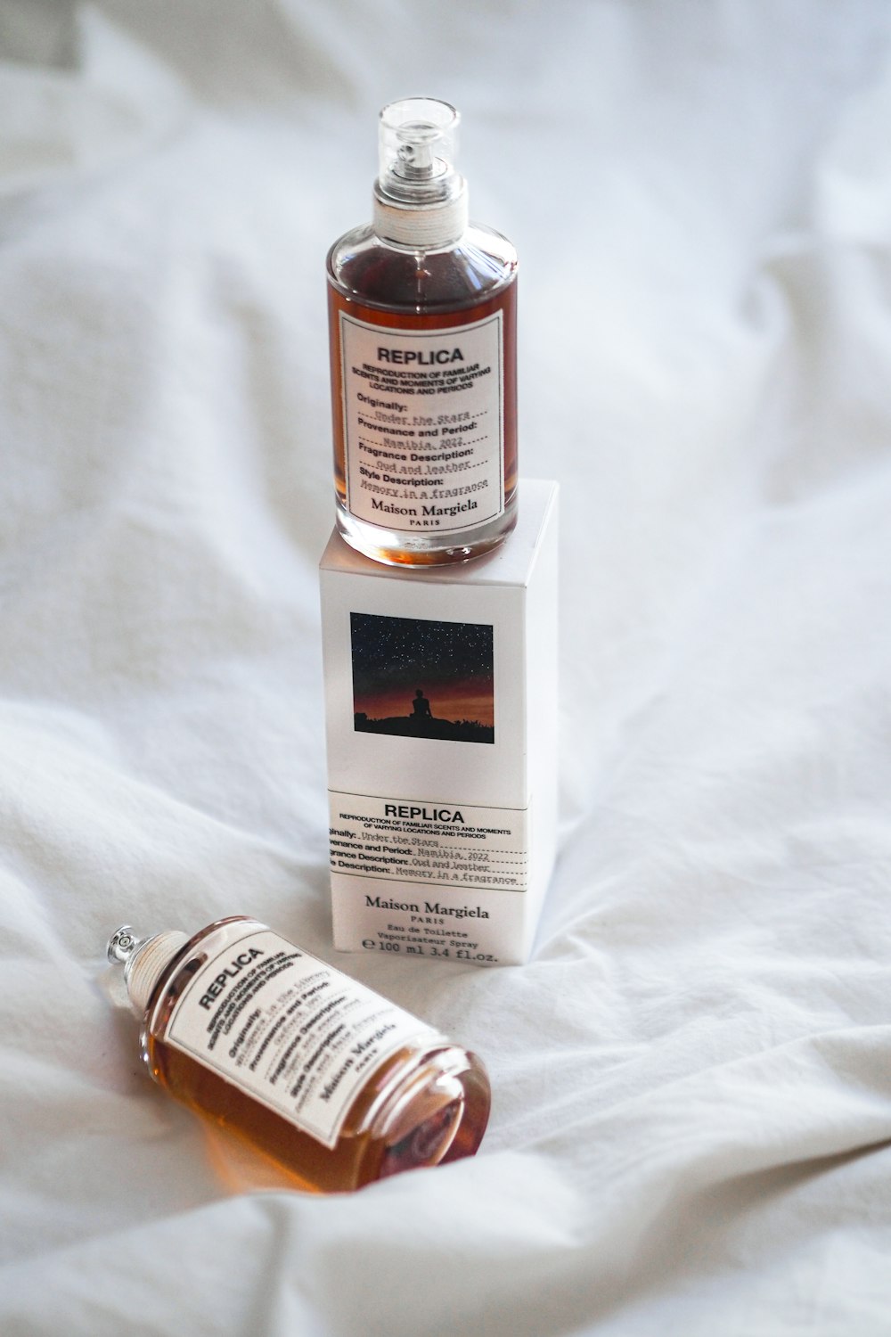 a bottle of medicine sitting on top of a bed