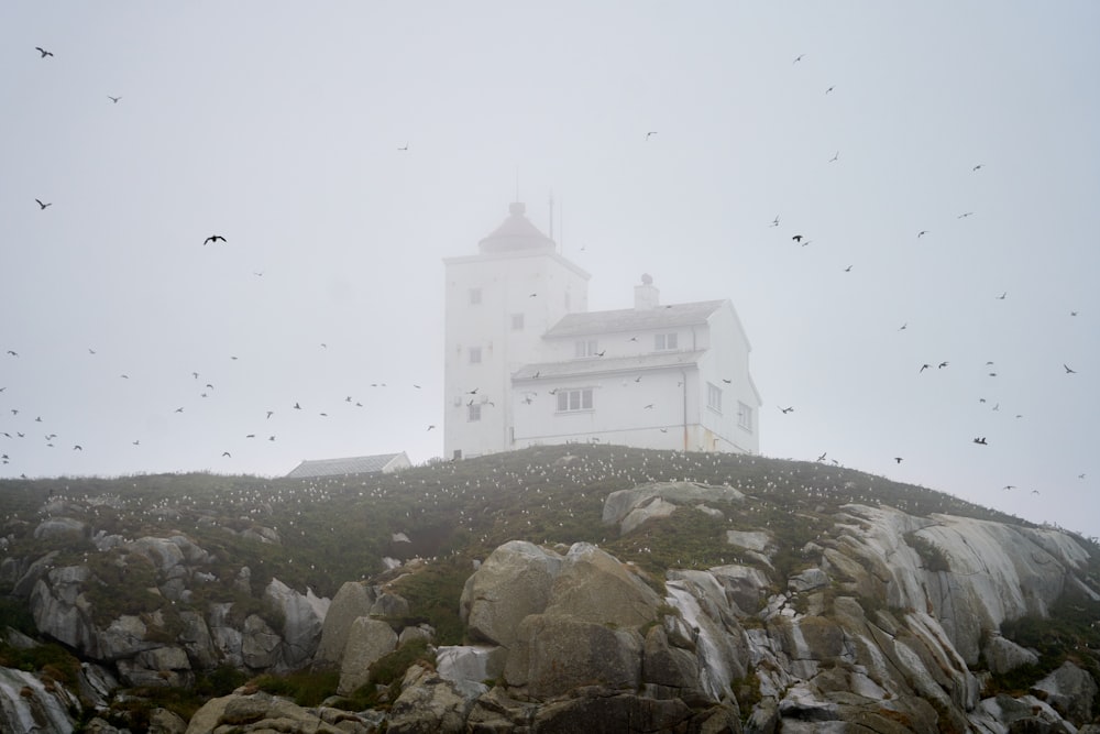 a large white building on top of a rocky hill