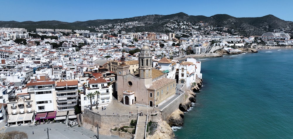 an aerial view of a city next to the ocean