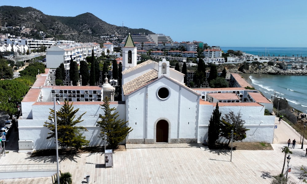 an aerial view of a church near the ocean