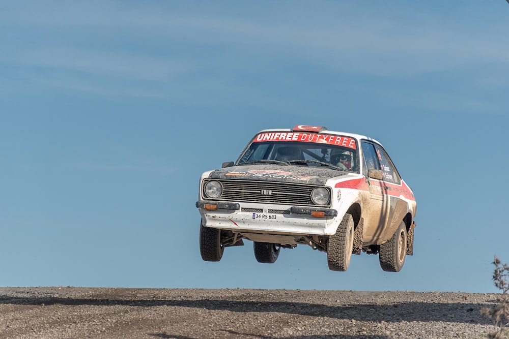 a rally car is flying through the air