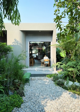 a person sitting at a table in a garden