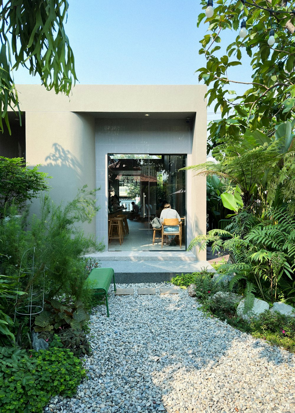 a person sitting at a table in a garden