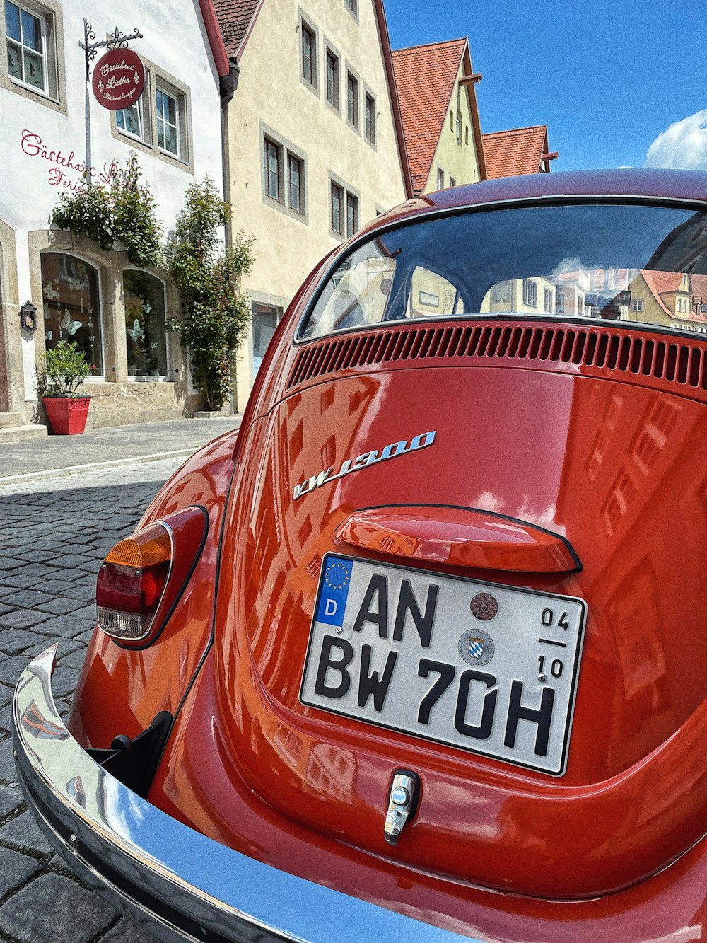 a red car parked on the side of a street