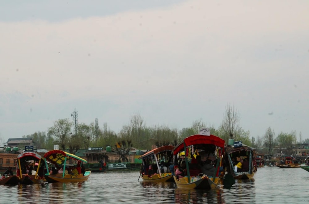 a group of boats floating on top of a river