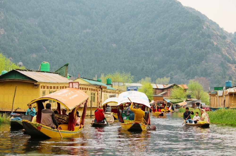 a group of people on small boats on a river