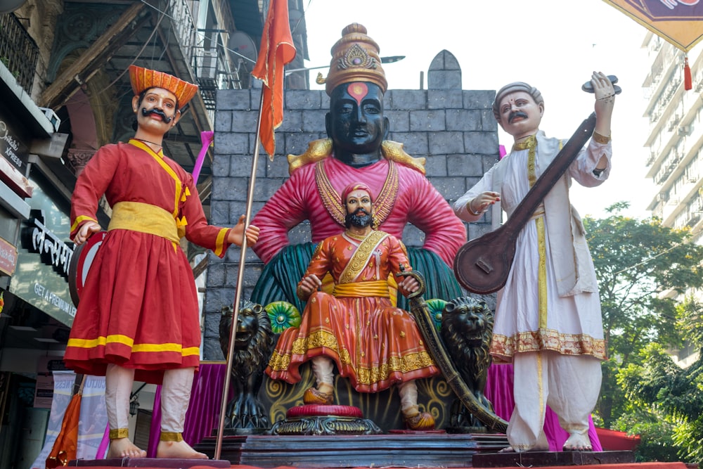 a group of men standing next to each other near a statue