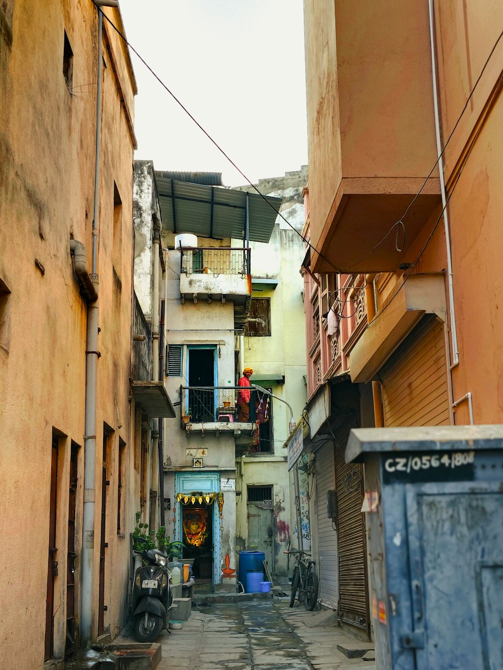 a narrow alleyway with a scooter parked on the side