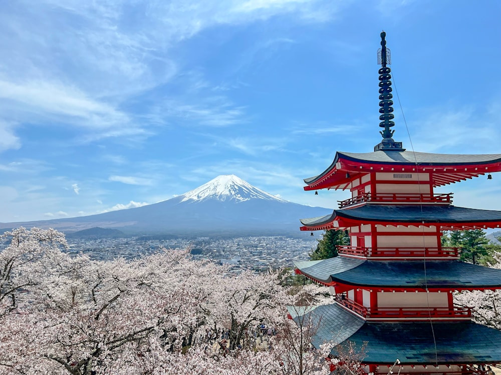 a tall pagoda with a mountain in the background