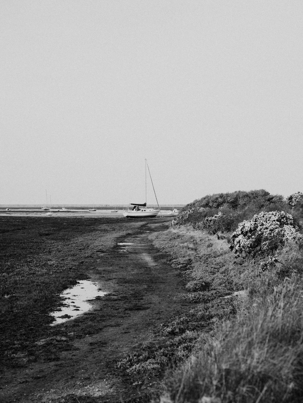 a black and white photo of a boat in the distance